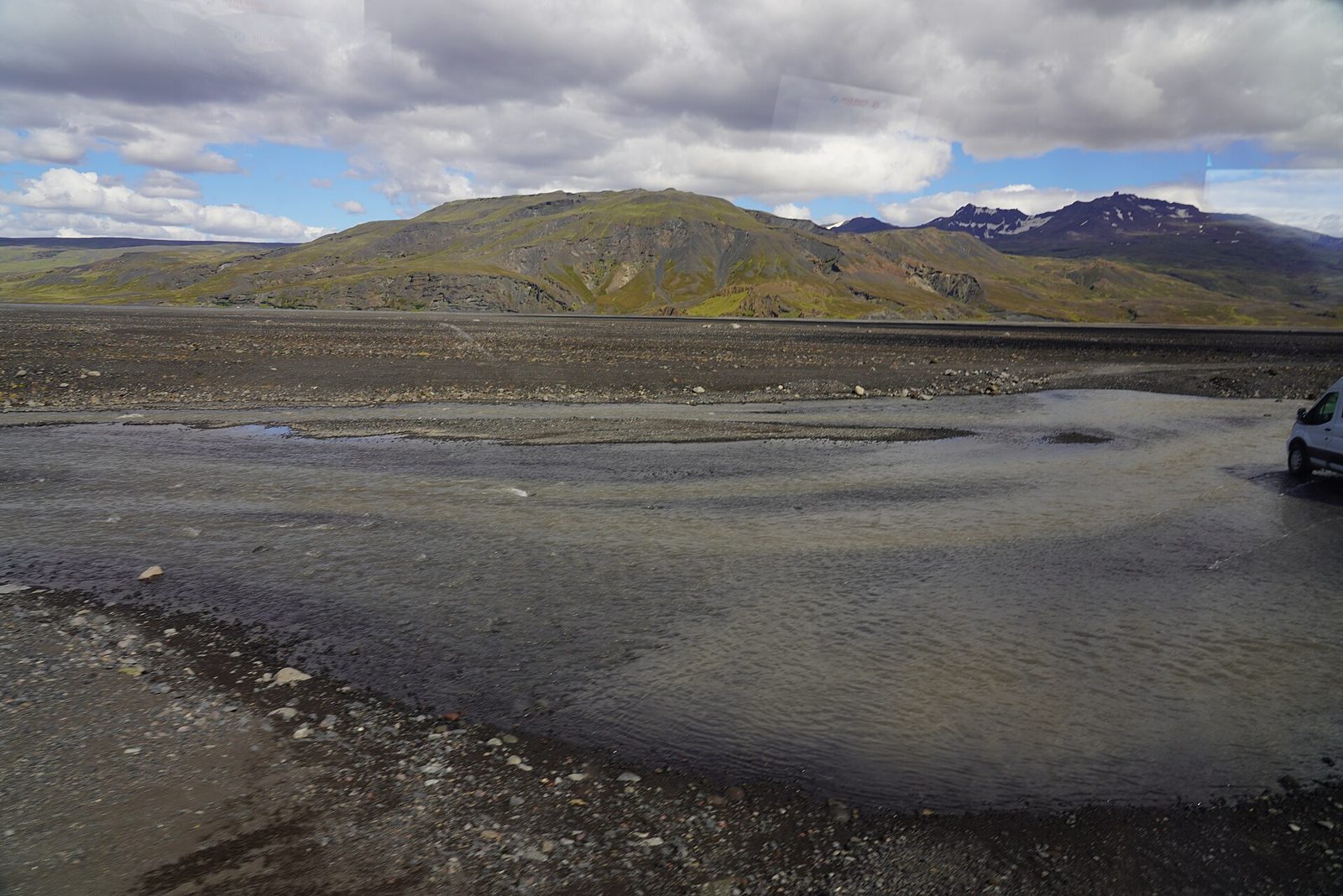 A 4×4 vehicle fording the glacial Krossá river near Þórsmörk