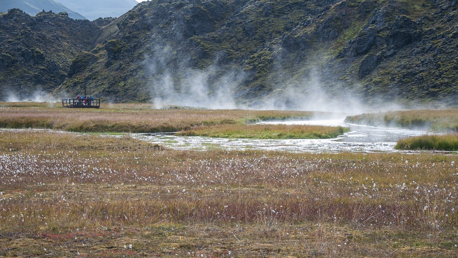 Steam rising from the warm bathing brook at Landmannalaugar, with the bathing platform at the edge of the Laugahraun lava field
