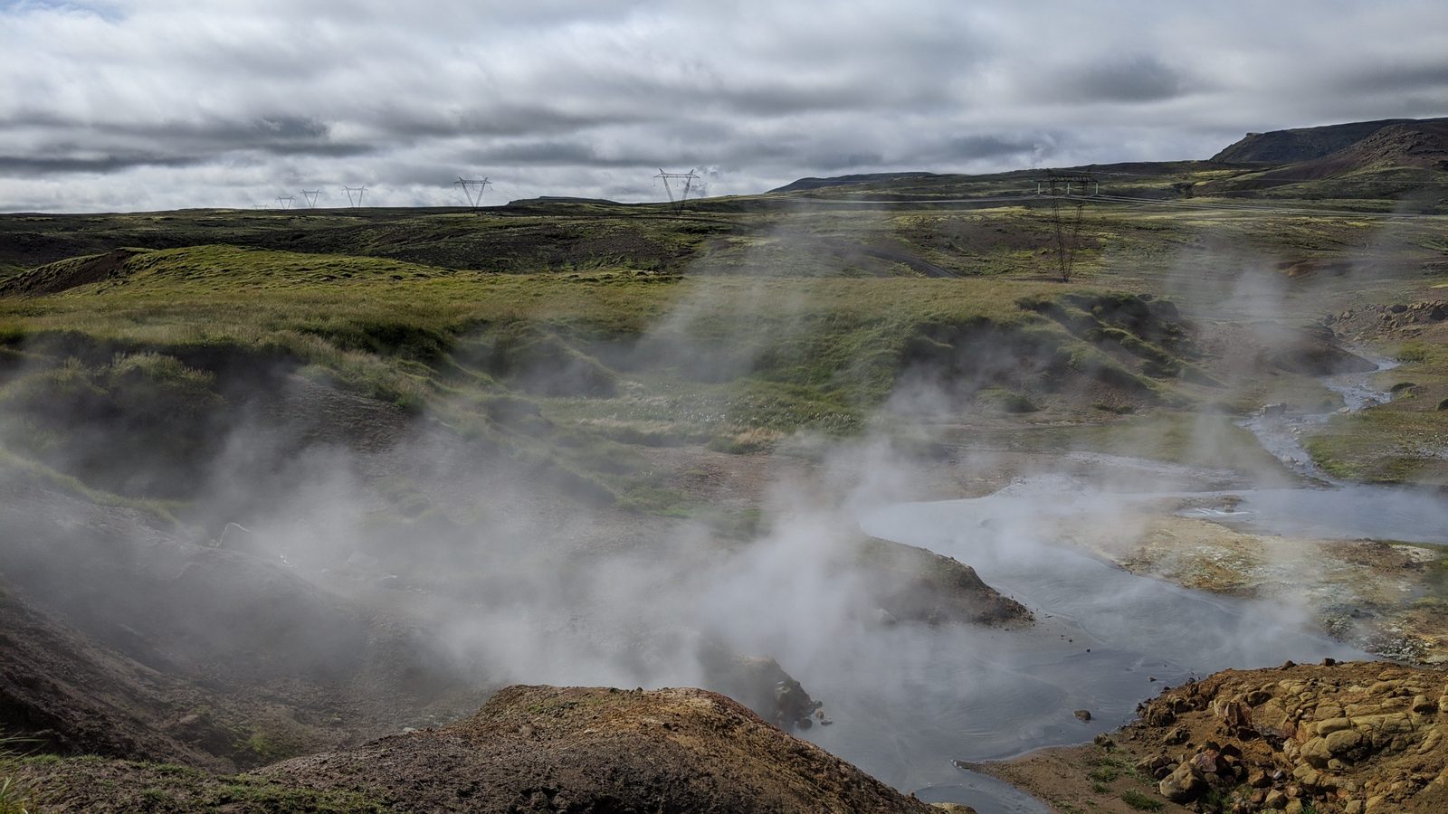 Steam rising from the warm thermal river in Reykjadalur valley, South Iceland
